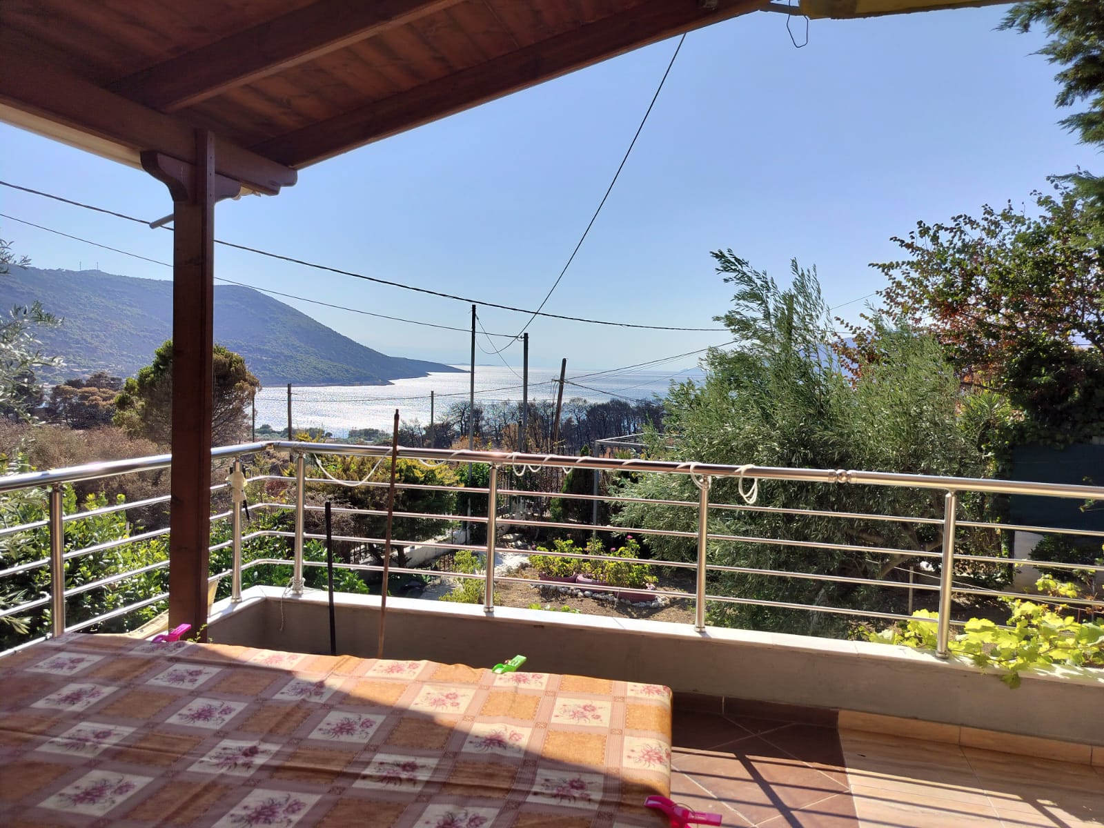 Covered terrace with panoramic sea and mountain view at Porto Germeno Villa
