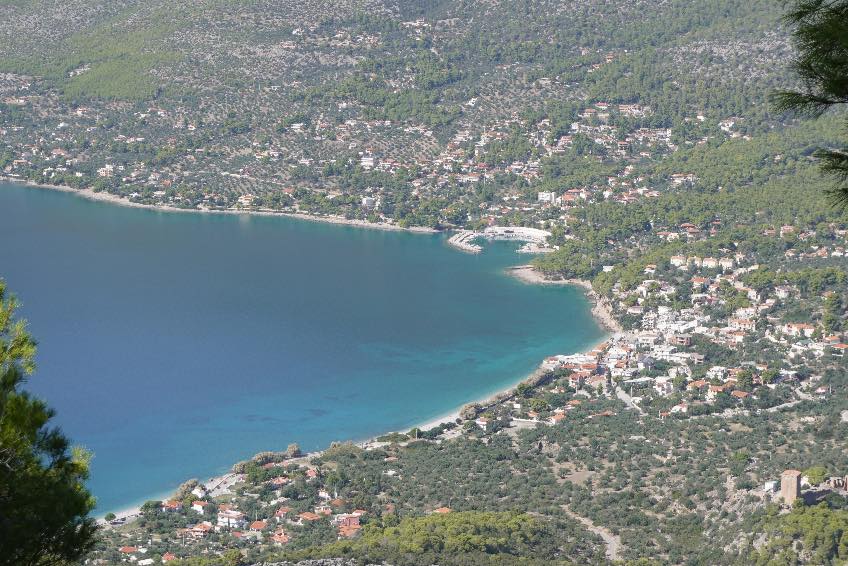 Aerial view of Porto Germeno village and bay surrounded by olive groves